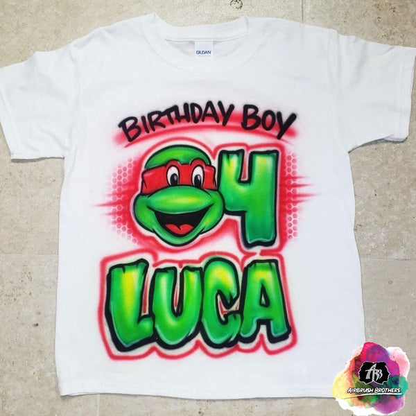 http://airbrushbrothers.com/cdn/shop/products/airbrush-airbrush-birthday-boy-ninja-turtle-shirt-design-airbrush-brothers-shirt-custom-spray-paint-design-shirt-hat-shoes-outfit-graffiti-t-shirts-birthday-90s-80s-28231888339022_grande.jpg?v=1687540427